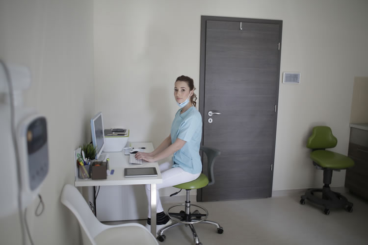A nurse using a website for patient records.