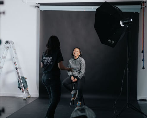 A woman in a photography studio getting her photo taken.